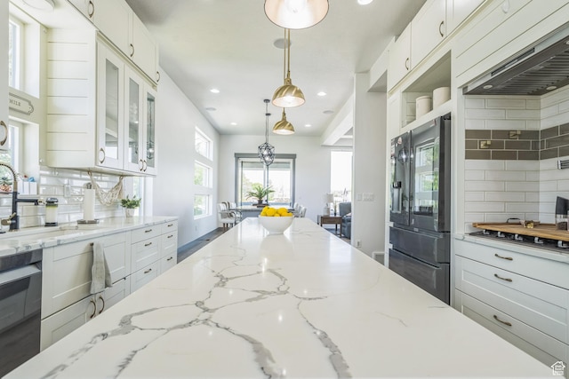 1186 W Marinwood Ave, Murray, UT 84123 - kitchen featuring backsplash, glass insert cabinets, recessed lighting, range hood, and white cabinets