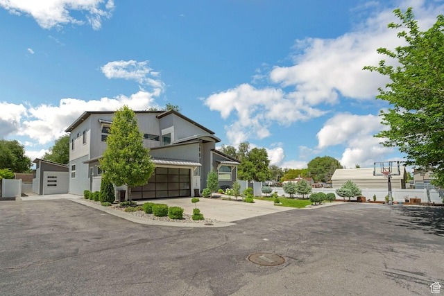 1186 W Marinwood Ave, Murray, UT 84123 - contemporary house with concrete driveway, stucco siding, and a garage