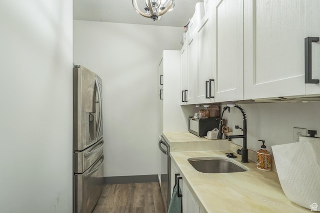 1186 W Marinwood Ave, Murray, UT 84123 - kitchen featuring appliances with stainless steel finishes, light countertops, a sink, white cabinetry, and dark wood-style flooring