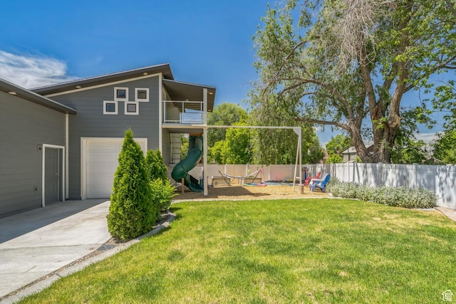 1186 W Marinwood Ave, Murray, UT 84123 - view of yard featuring a playground, driveway, an attached garage, and a balcony