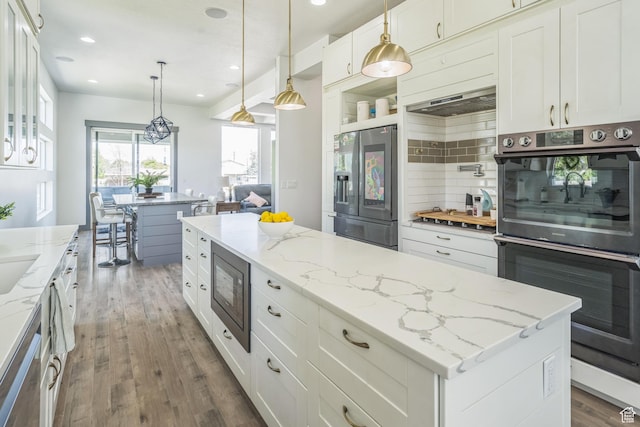 1186 W Marinwood Ave, Murray, UT 84123 - kitchen featuring multiple ovens, stainless steel refrigerator with ice dispenser, built in microwave, wood finished floors, and range hood