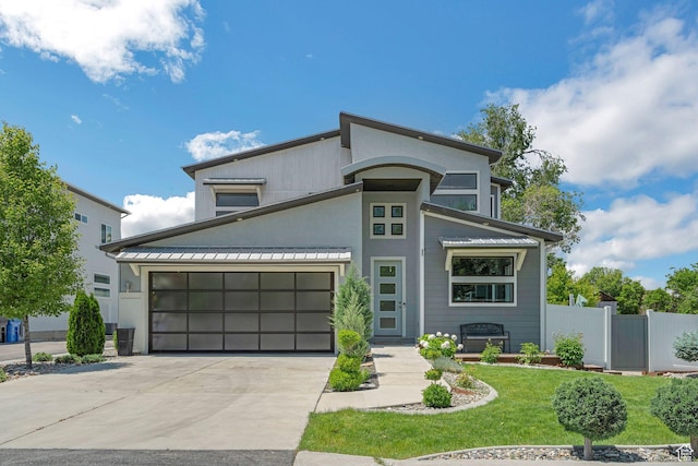 1186 W Marinwood Ave, Murray, UT 84123 - contemporary home with concrete driveway, stucco siding, and a garage