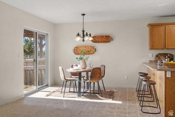 8064 N Clearwater Rd, Eagle Mountain, UT 84005 - dining room featuring a chandelier and baseboards