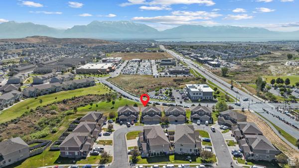 8064 N Clearwater Rd, Eagle Mountain, UT 84005 - aerial view of property and surrounding area featuring a mountain backdrop and nearby suburban area