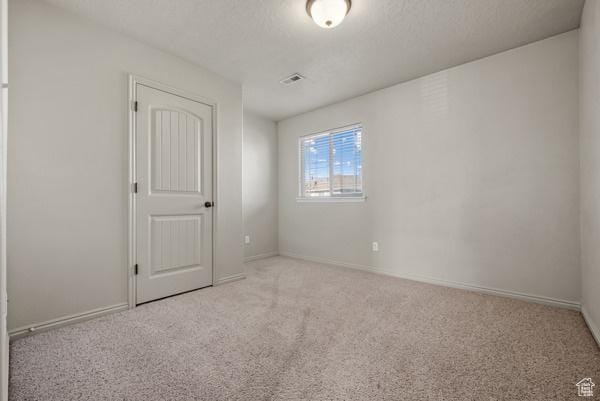 8064 N Clearwater Rd, Eagle Mountain, UT 84005 - unfurnished bedroom with carpet flooring, baseboards, and a textured ceiling