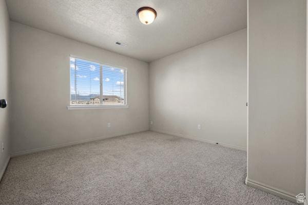 8064 N Clearwater Rd, Eagle Mountain, UT 84005 - carpeted spare room featuring baseboards and a textured ceiling