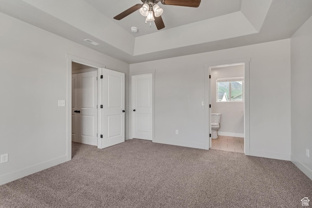 182 W Braeburn Ln, Santaquin, UT 84655 - unfurnished bedroom featuring light carpet, baseboards, ensuite bathroom, and a tray ceiling