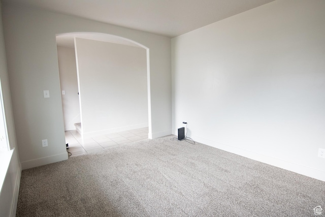 182 W Braeburn Ln, Santaquin, UT 84655 - unfurnished room with light colored carpet, arched walkways, light tile patterned flooring, and baseboards