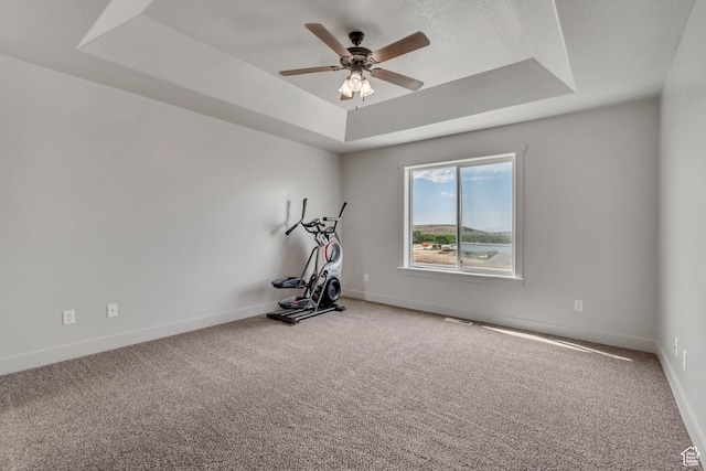 182 W Braeburn Ln, Santaquin, UT 84655 - workout area featuring a tray ceiling, ceiling fan, baseboards, and carpet floors