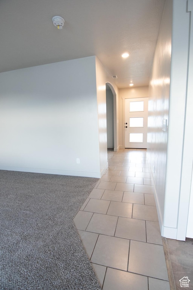 182 W Braeburn Ln, Santaquin, UT 84655 - hallway featuring arched walkways, baseboards, light tile patterned floors, and recessed lighting