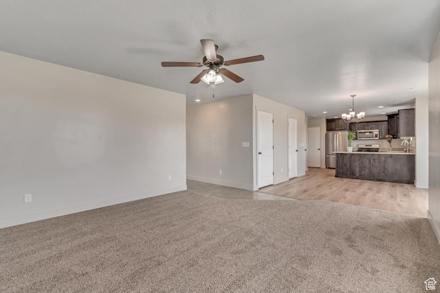 182 W Braeburn Ln, Santaquin, UT 84655 - unfurnished living room with light colored carpet, a chandelier, a ceiling fan, baseboards, and recessed lighting