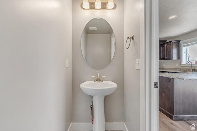 182 W Braeburn Ln, Santaquin, UT 84655 - bathroom with baseboards, a textured ceiling, wood finished floors, and a sink