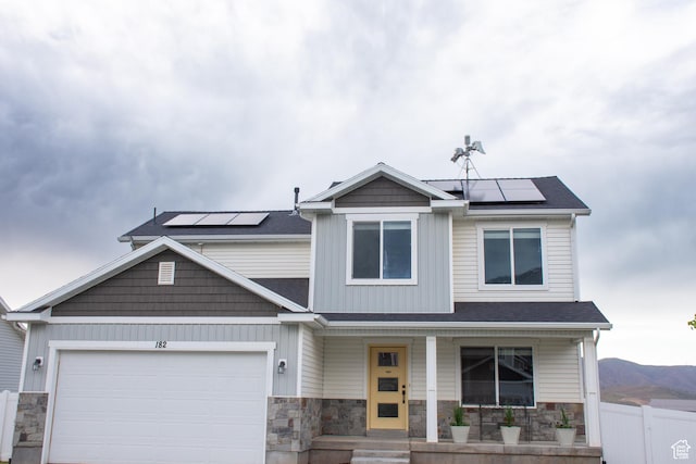 182 W Braeburn Ln, Santaquin, UT 84655 - view of front of house with a porch, roof mounted solar panels, and stone siding