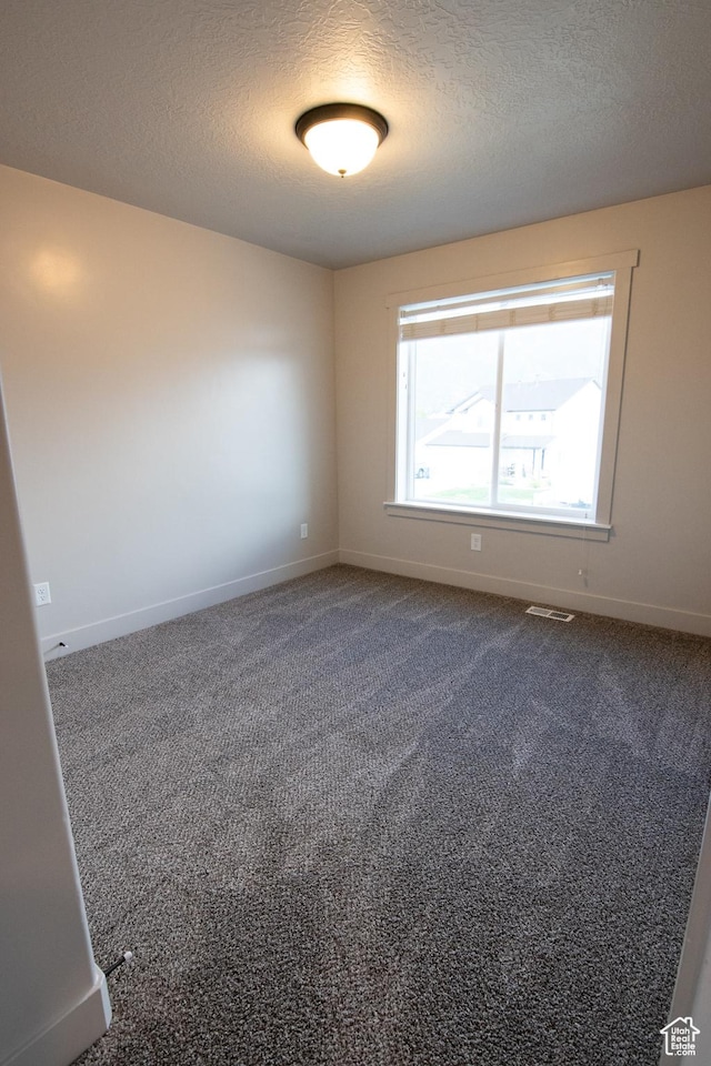 182 W Braeburn Ln, Santaquin, UT 84655 - empty room with baseboards, a textured ceiling, and dark colored carpet