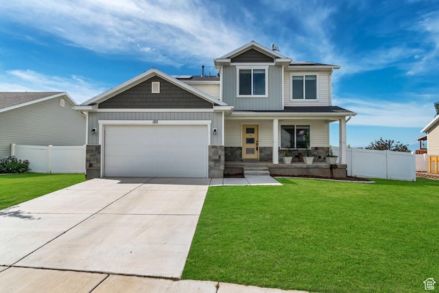 182 W Braeburn Ln, Santaquin, UT 84655 - view of front of home featuring a porch, a garage, concrete driveway, stone siding, and roof mounted solar panels