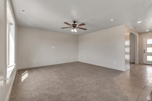 182 W Braeburn Ln, Santaquin, UT 84655 - spare room with arched walkways, a ceiling fan, baseboards, and light carpet