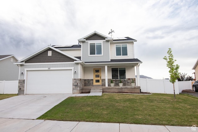 182 W Braeburn Ln, Santaquin, UT 84655 - view of front of property with a porch, a garage, stone siding, roof mounted solar panels, and concrete driveway