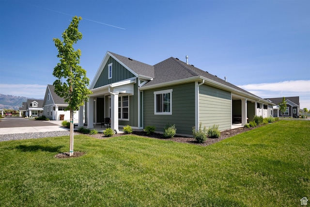 3795 S 4250 W Unit 446D, West Haven, UT 84401 - view of front facade with a front yard, board and batten siding, driveway, and roof with shingles