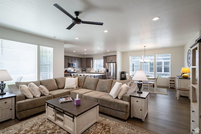 3795 S 4250 W Unit 446D, West Haven, UT 84401 - living area with dark wood-type flooring, healthy amount of natural light, ceiling fan, a chandelier, and recessed lighting