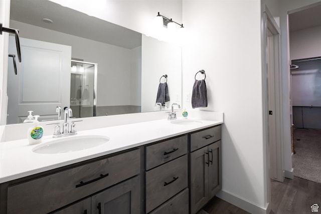 3795 S 4250 W Unit 446D, West Haven, UT 84401 - bathroom featuring double vanity, wood finished floors, a walk in closet, and baseboards