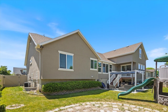 2127 Rio Grande Dr, Spanish Fork, UT 84660 - rear view of property with stucco siding, a playground, cooling unit, and a gate