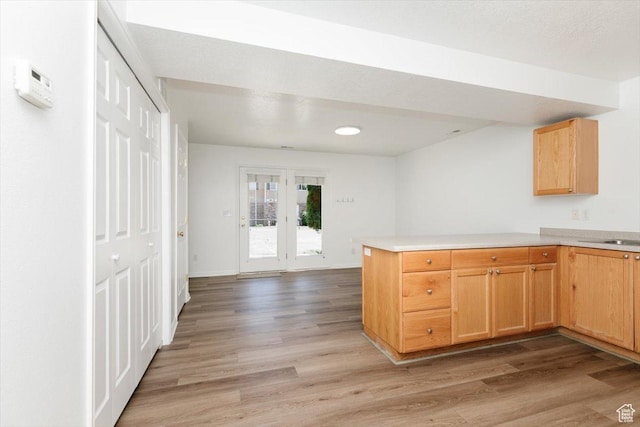 356 S 400 W, Logan, UT 84321 - kitchen featuring light wood-style flooring, a peninsula, light countertops, and light brown cabinetry