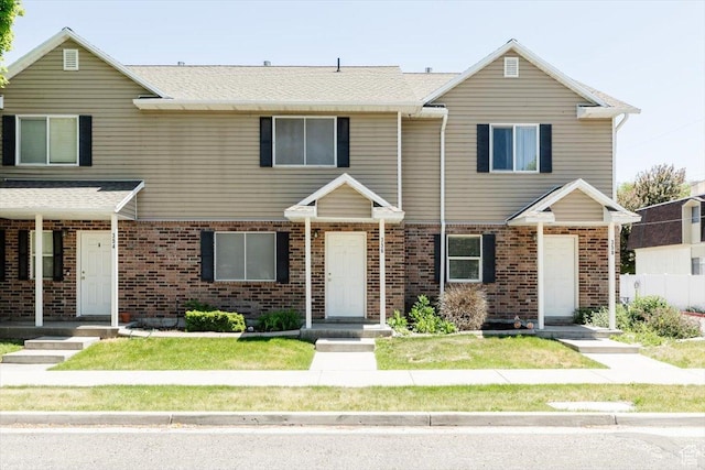 356 S 400 W, Logan, UT 84321 - townhome / multi-family property with brick siding, a front yard, and a shingled roof