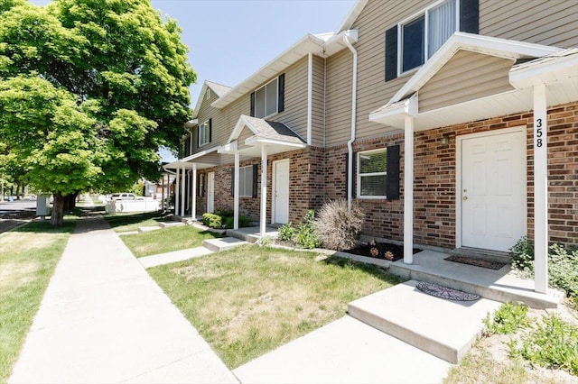 356 S 400 W, Logan, UT 84321 - view of front facade featuring brick siding and a front lawn