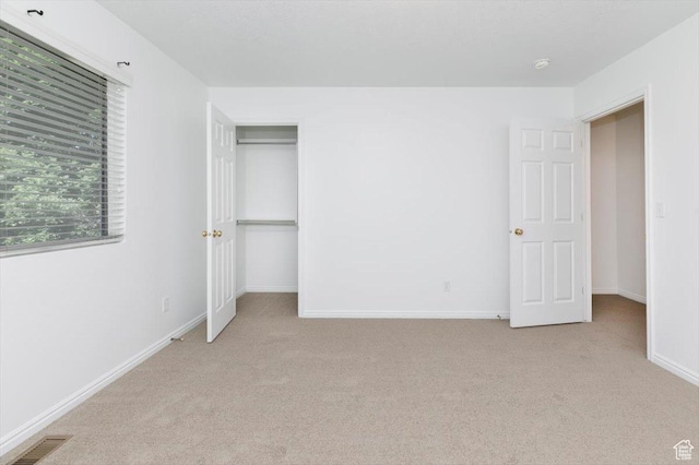 356 S 400 W, Logan, UT 84321 - unfurnished bedroom with light colored carpet, baseboards, and a closet