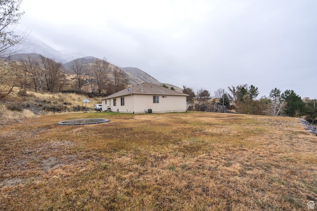 3870 W Mountaintop Cir, Cedar Hills, UT 84062 - view of grassy yard featuring a trampoline and a mountain view