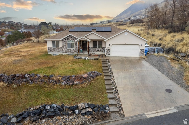 3870 W Mountaintop Cir, Cedar Hills, UT 84062 - ranch-style house with a garage, driveway, a yard, solar panels, and stucco siding