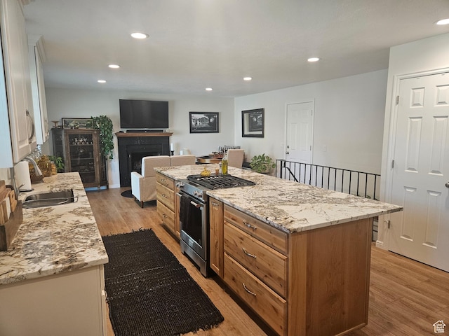 5235 S Spring Clover Dr W, Salt Lake City, UT 84123 - kitchen featuring gas stove, light wood finished floors, a fireplace, recessed lighting, and a sink