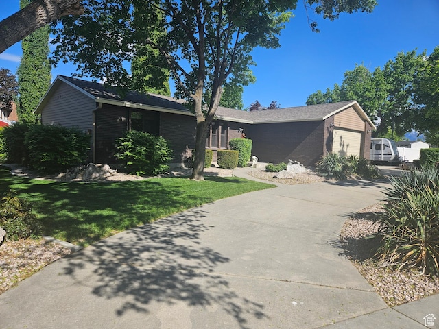 5235 S Spring Clover Dr W, Salt Lake City, UT 84123 - single story home with concrete driveway, brick siding, a garage, and a front lawn