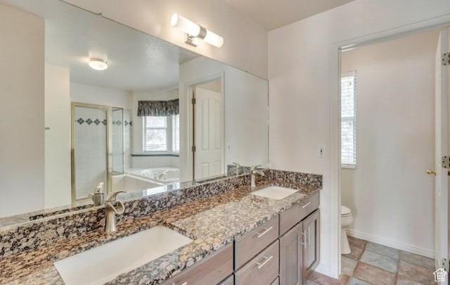 1231 E Tierney Cir, Sandy, UT 84094 - bathroom with a garden tub, double vanity, toilet, a shower stall, and baseboards