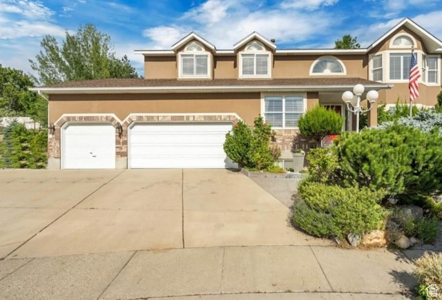 1231 E Tierney Cir, Sandy, UT 84094 - view of front facade featuring driveway, stucco siding, and an attached garage