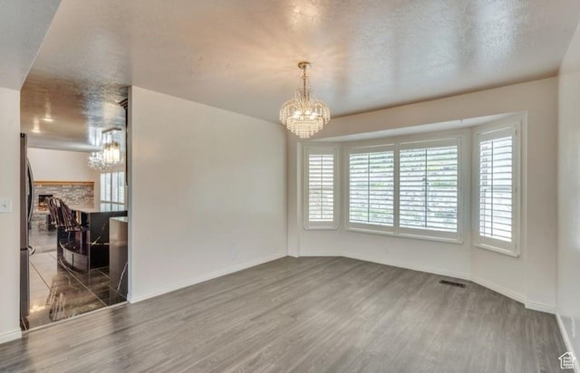 1231 E Tierney Cir, Sandy, UT 84094 - unfurnished dining area featuring a chandelier, wood finished floors, and plenty of natural light