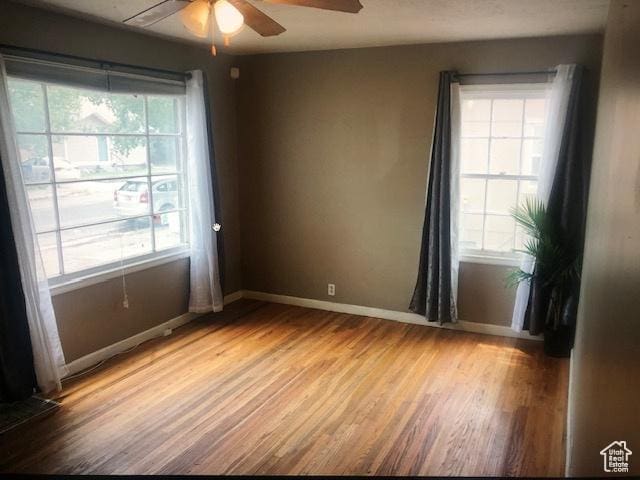 2726 S Cyprus Ln, Magna, UT 84044 - unfurnished room with plenty of natural light, a ceiling fan, light wood finished floors, and baseboards