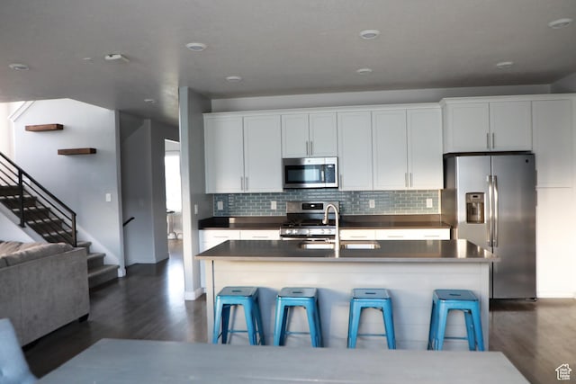 7315 N Stone Wall Cir, Eagle Mountain, UT 84005 - kitchen with stainless steel appliances, dark wood-type flooring, dark countertops, and a sink