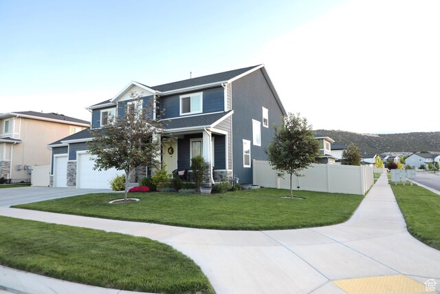 7315 N Stone Wall Cir, Eagle Mountain, UT 84005 - view of front of house with concrete driveway, covered porch, and stone siding