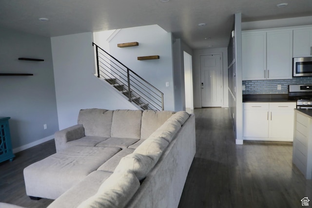 7315 N Stone Wall Cir, Eagle Mountain, UT 84005 - living room with dark wood-type flooring, stairs, baseboards, and recessed lighting