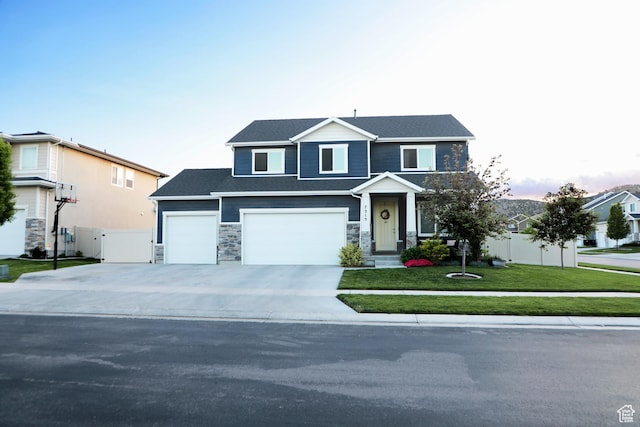 7315 N Stone Wall Cir, Eagle Mountain, UT 84005 - view of front of home featuring concrete driveway, stone siding, and a garage