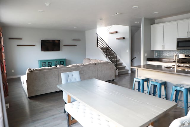7315 N Stone Wall Cir, Eagle Mountain, UT 84005 - dining area with dark wood-style flooring, stairway, and baseboards