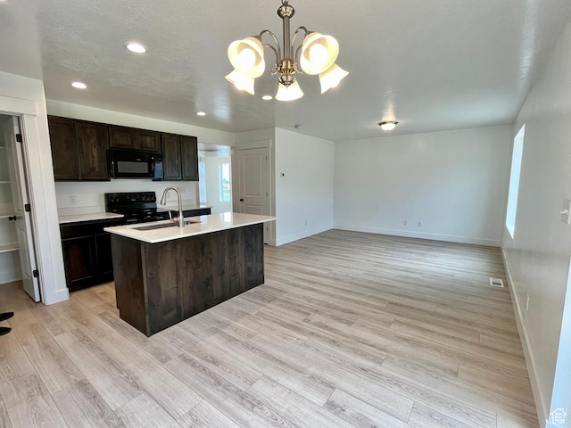 1937 S Freestone Blvd, Santaquin, UT 84655 - kitchen featuring black appliances, a sink, baseboards, light countertops, and a kitchen island with sink