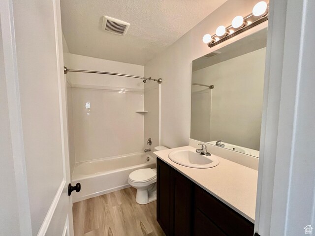 1937 S Freestone Blvd, Santaquin, UT 84655 - full bathroom with wood finished floors, vanity, shower / bath combination, toilet, and a textured ceiling