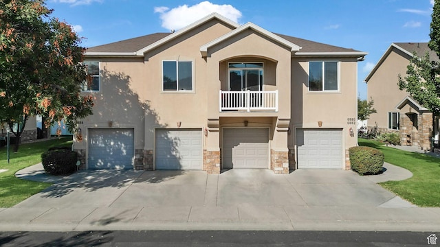 6882 W Bamburgh Way W, West Valley City, UT 84128 - multi unit property with an attached garage, stucco siding, stone siding, driveway, and a front yard
