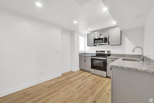 6034 S 2900 W, Roy, UT 84067 - kitchen featuring stainless steel appliances, a sink, light stone countertops, gray cabinetry, and light wood-type flooring