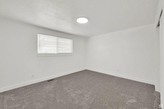6034 S 2900 W, Roy, UT 84067 - empty room with dark colored carpet, baseboards, and a textured ceiling