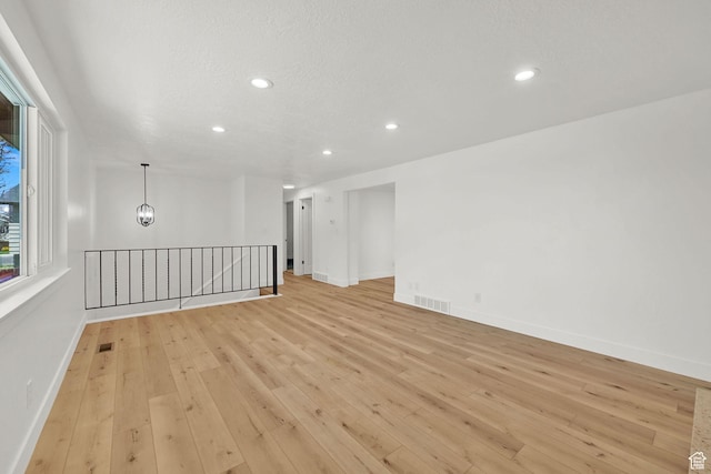 6034 S 2900 W, Roy, UT 84067 - empty room featuring light wood-style floors, recessed lighting, and baseboards
