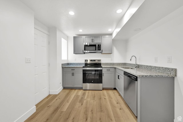 6034 S 2900 W, Roy, UT 84067 - kitchen featuring appliances with stainless steel finishes, a sink, gray cabinetry, light wood-style flooring, and recessed lighting