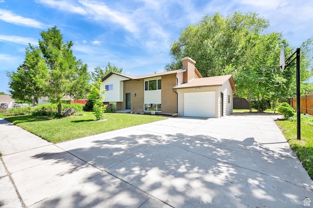 6034 S 2900 W, Roy, UT 84067 - bi-level home with concrete driveway, a garage, and a chimney